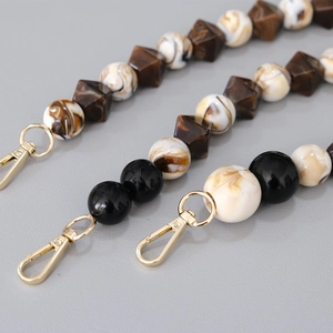 Detail of vintage acrylic bead chains in brown marble and black with gold metal clasps