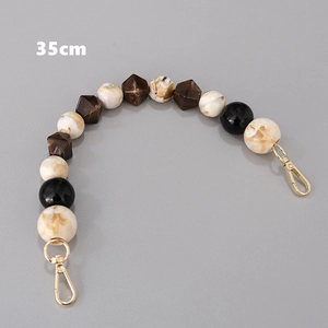Detail of a 35cm vintage beaded bag chain with brown marble acrylic beads and gold clasps