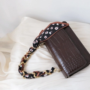 Elegant dark brown crocodile pattern handbag featuring a luxury silk scarf chain strap
