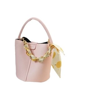 Pink lychee grain leather bucket bag featuring a decorative durian print silk scarf chain