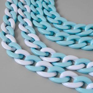 Detail of blue and white acrylic fishbone chain links with glossy resin finish for bags