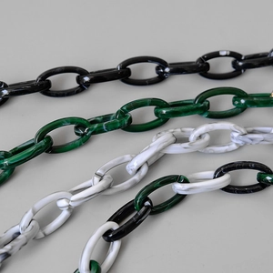 Macro shot of marble-patterned resin chain links for bags and accessories in three colors