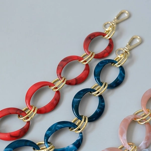 Detail of colorful resin chain straps with gold links and lobster clasps for bags