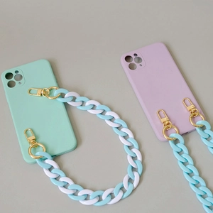 Detail of mint green and lavender silicone cases with blue acrylic chunky chain straps