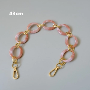 Detail view of 43cm pink marble resin and gold metal link chain strap for bags