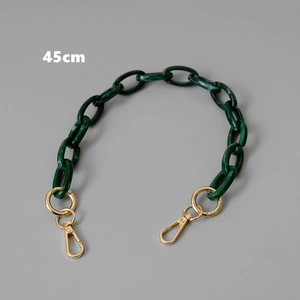 Macro detail of a 45cm dark green marble resin bag strap with gold spring ring clasps