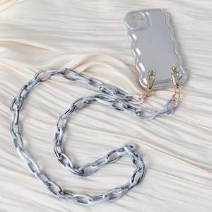 Close-up of wavy silver phone case with black and white marble resin hand chain link
