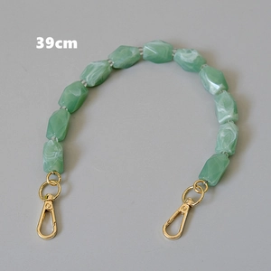 Detailed view of 39cm green marbled resin bead bag chain with golden metal clasps