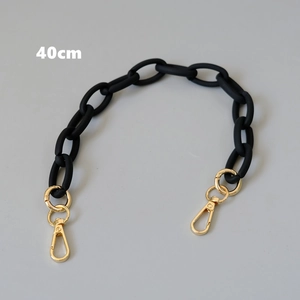 Detailed view of 40cm matte black acrylic chunky bag strap with golden metal lobster clasps