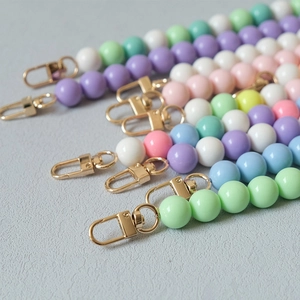 Detail of colorful macaron bead straps with high-gloss gold lobster clasps in various colors