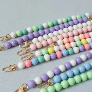 Close-up of macaron color handmade resin bead chains with golden lobster clasps