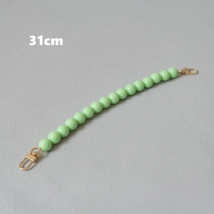 Detail view of 31cm mint green acrylic bead strap with golden metal lobster clasps