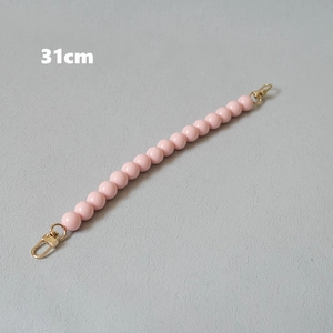 Detail of 31cm pink beaded chain with gold lobster clasps for bags or phone accessories