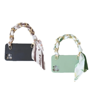 Smartphone case with decorative gold chain and floral silk scarf handle in black and mint