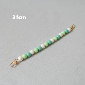 Detail of 31cm beaded bag strap with white and green pearls and gold lobster clasps