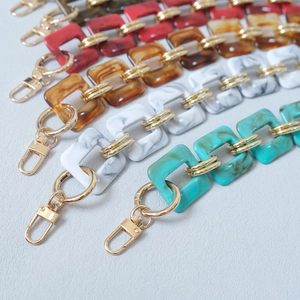 Close-up of vintage acrylic resin bag chains with diverse textures and gold metal clasps