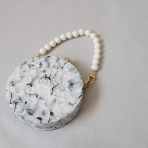 Round marble pattern acrylic clutch bag with pearl bead handle and gold metal clasp