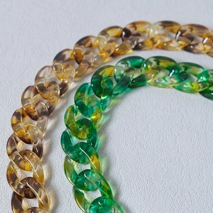 Close-up of amber and marble resin chain links for DIY bags and fashion accessories
