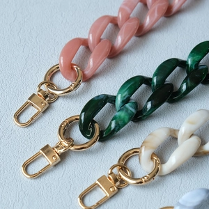 Detail of acrylic bag chains in candy colors with high-quality gold lobster clasps