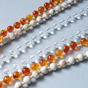 Macro detail of acrylic candy colored beads with amber marble texture and clear resin finish
