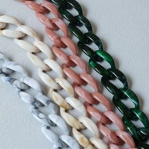 Macro view of acrylic resin bag chains with marble texture in four stylish candy colors