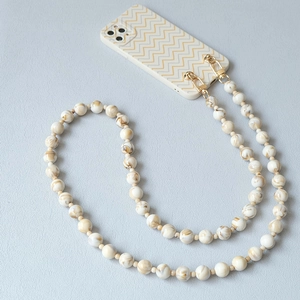 Detailed close-up of marble-textured acrylic bead strap with a gold metal lobster clasp