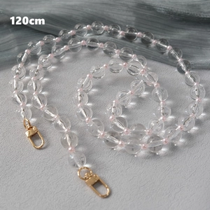 Macro view of 120cm acrylic bead crossbody chain with transparent pink beads and gold clasps