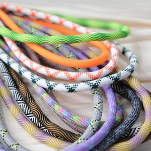 Close-up of colorful braided crossbody phone straps with various patterns and textures