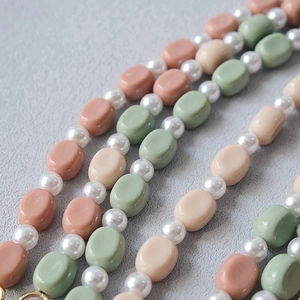 Detail of candy-colored acrylic beaded chain with Morandi tones and gold metal ring clasps