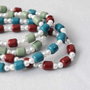 Detail of candy color acrylic bead strap with polished resin beads and pearl texture