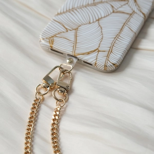 Detail of white leaf pattern phone case with detachable gold metal chain strap