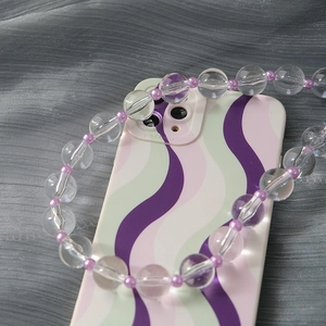 Detailed view of translucent acrylic bead chain and wave-patterned protective phone case