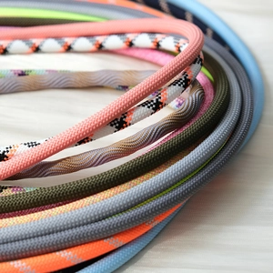 Detail of colorful braided mobile phone lanyards showing texture and diverse patterns