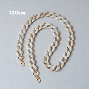 Detail of 120cm resin bag strap with ivory and brown marble texture and gold lobster clasps