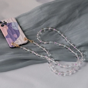 Detail of colorful acrylic bead strap with transparent beads and golden metal lobster clasp