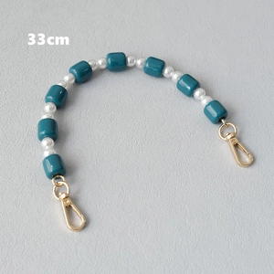 Detail of 33cm bag strap with deep teal resin beads, white pearls and gold metal clasps