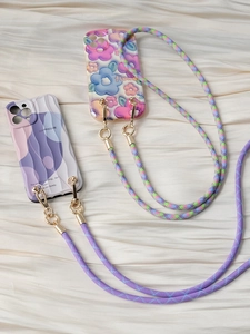 Detail view of woven phone lanyards with floral pattern and golden metal buckles