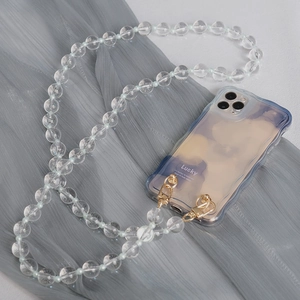 Detail of transparent wavy phone case with rounded acrylic bead crossbody strap and gold clips