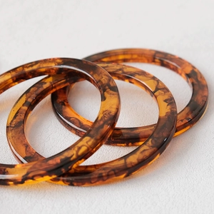 Macro detail of three amber resin round handles with vintage tortoiseshell texture