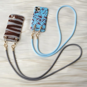 Stylish woven crossbody phone lanyard straps with chic patterned cases and gold metal clips