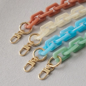 Detail of colorful acrylic resin chains with high-gloss gold lobster clasps and rings