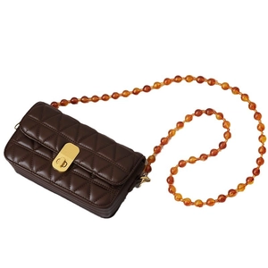 Dark coffee quilted leather bag with amber acrylic bead strap and gold twist lock
