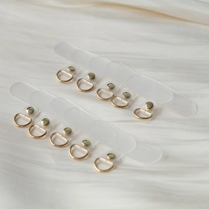 Close-up of translucent frosted TPU phone lanyard tabs with premium gold metal D-rings