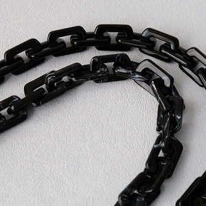 Detail of chunky black and marble resin chain strap for fashion shoulder bags and phones