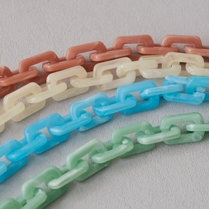 Close-up of colorful acrylic resin thick chains for handbags in pastel macaron colors