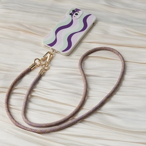 Detail of purple braided phone strap with gold hooks on a wavy pattern phone case