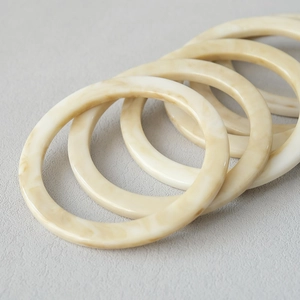 Detail of 11.8cm vintage marble resin bag handles showing cream and coffee tortoiseshell texture