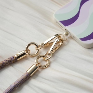 Detailed macro view of purple woven phone strap with gold-tone metallic hardware and lobster clasps