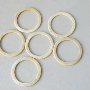 Close-up of 11.8cm marble pattern resin rings with amber acrylic texture for DIY crafts
