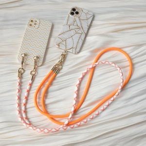 Close-up of thick woven phone lanyards with premium gold metal clasps on wavy patterned cases
